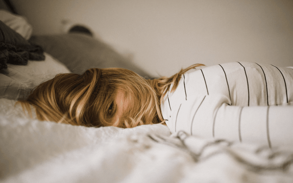 Person laying on stomach in bed